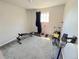 This bedroom is currently used as a workout room; it has neutral carpet, lots of light and an elliptical at 5677 S Lowell Blvd, Littleton, CO 80123