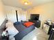 Bedroom with neutral walls, neutral carpet, a closet, a bed, and a TV on a dresser at 5677 S Lowell Blvd, Littleton, CO 80123