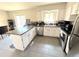Bright kitchen with stainless steel appliances, granite countertops, an island and sliding doors at 5677 S Lowell Blvd, Littleton, CO 80123
