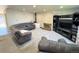 Spacious living room with a fireplace, gray carpet, and a comfortable sectional sofa at 5677 S Lowell Blvd, Littleton, CO 80123