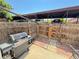 Cozy fenced patio features a gas grill, wooden gate, and access to covered parking spaces at 5677 S Lowell Blvd, Littleton, CO 80123