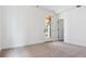 Bright bedroom with neutral carpet, white walls, and a glass door leading to a patio at 8376 Cokedale Dr, Littleton, CO 80125