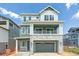 Inviting two-story home featuring stylish gray siding, brick accents, and a covered front porch at 8376 Cokedale Dr, Littleton, CO 80125