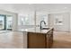 Open kitchen with an island with seating, sleek countertops, and bright, open space at 8376 Cokedale Dr, Littleton, CO 80125