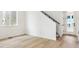 Light-filled living room showcasing wood-look flooring, white walls, and access to a backyard at 8376 Cokedale Dr, Littleton, CO 80125