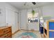 Bright bedroom with closet, wood floors, and blue and brown bunk beds at 2045 Jamaica St, Aurora, CO 80010