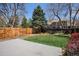 Spacious backyard features a concrete patio, a well-maintained lawn, and a wood fence, perfect for outdoor entertaining at 1566 S Syracuse St, Denver, CO 80231