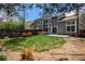 Backyard with a well-maintained lawn, patio, and privacy fence, creating a serene outdoor space at 1566 S Syracuse St, Denver, CO 80231