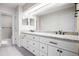Bathroom with granite countertops and double sinks, illuminated by recessed lighting at 1566 S Syracuse St, Denver, CO 80231