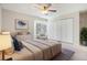 Cozy bedroom features soft carpeting, a ceiling fan, and double door closet at 1566 S Syracuse St, Denver, CO 80231