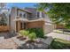 Exterior showcases a well-maintained home with brick accents and a two-car garage at 1566 S Syracuse St, Denver, CO 80231