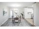 Open concept dining area with kitchen access and a chandelier at 3711 S Uinta St, Denver, CO 80237