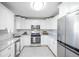 Modern kitchen with white shaker cabinets, granite counters, and stainless steel appliances at 3711 S Uinta St, Denver, CO 80237