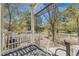 Spacious backyard with a white fence, lawn area, mature trees, and view from covered porch at 2428 Concord Cir, Lafayette, CO 80026