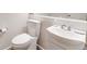 Bathroom with a white toilet and sink, and mirrored vanity at 2428 Concord Cir, Lafayette, CO 80026