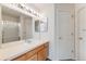 Large bathroom with a double vanity, large mirror, recessed lighting, and a shower-tub combo at 2428 Concord Cir, Lafayette, CO 80026