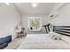 This bedroom has a bright, all-white motif, a large window, and workout equipment for convenience at 2428 Concord Cir, Lafayette, CO 80026