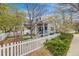 Charming exterior elevation with a white picket fence, garden, and inviting front porch at 2428 Concord Cir, Lafayette, CO 80026