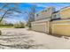 Exterior view of a two-story home with attached garage and spacious driveway on a sunny day at 2428 Concord Cir, Lafayette, CO 80026