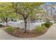 Charming front yard with a white picket fence, mature trees, and lush landscaping at 2428 Concord Cir, Lafayette, CO 80026