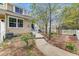 Landscaped front yard with a concrete walkway and garden bed filled with blooming flowers at 2428 Concord Cir, Lafayette, CO 80026