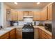 Kitchen features stainless steel appliances and light wood cabinets at 2428 Concord Cir, Lafayette, CO 80026