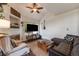 Cozy living room features a fireplace, ceiling fan, and decorative touches at 2428 Concord Cir, Lafayette, CO 80026