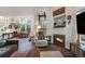 Bright living room features a fireplace, vaulted ceiling, comfortable seating, and large windows at 2428 Concord Cir, Lafayette, CO 80026
