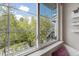 Bright window view overlooking the property's landscape featuring mature green trees and blue sky at 2428 Concord Cir, Lafayette, CO 80026