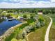 Aerial view of a pond with a gazebo, walking path, and lush green landscape at 5451 W 73Rd Ave, Westminster, CO 80003