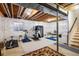Unfinished basement with exposed ceiling, carpet rugs, and workout equipment at 5451 W 73Rd Ave, Westminster, CO 80003