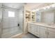 Modern bathroom featuring a glass-enclosed shower and double vanity sinks at 5451 W 73Rd Ave, Westminster, CO 80003