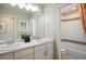 Well-lit bathroom with double sinks, white cabinets, and a separate toilet room at 5451 W 73Rd Ave, Westminster, CO 80003