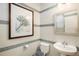 Elegant powder room featuring stylish tile work, a pedestal sink, and decorative wall art at 5451 W 73Rd Ave, Westminster, CO 80003