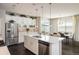 Bright kitchen boasts a large island, stainless steel appliances, white cabinets, and an adjacent dining area at 5451 W 73Rd Ave, Westminster, CO 80003