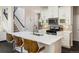 Stylish kitchen featuring a large island with seating, stainless steel appliances, and sleek white cabinetry at 5451 W 73Rd Ave, Westminster, CO 80003