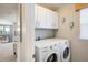 Convenient laundry room with white cabinets and a modern washer and dryer at 5451 W 73Rd Ave, Westminster, CO 80003