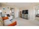 Cozy living room with neutral walls, carpet, and colorful storage unit at 5451 W 73Rd Ave, Westminster, CO 80003