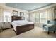 Inviting main bedroom featuring tray ceiling, large windows, and modern decor at 5451 W 73Rd Ave, Westminster, CO 80003