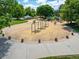 A well-maintained playground with swings, slides, and a wood chip surface, surrounded by green trees at 5451 W 73Rd Ave, Westminster, CO 80003