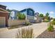 Attractive two-story townhome with blue siding, a garage, and manicured landscaping at 5451 W 73Rd Ave, Westminster, CO 80003