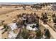An aerial view shows this home with a red tile roof surrounded by an expansive, treed property in a rural setting at 5582 Twilight Way, Parker, CO 80134