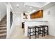 Finished basement featuring a kitchenette with a breakfast bar, and a staircase at 5582 Twilight Way, Parker, CO 80134