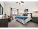 Cozy bedroom featuring a large bed, a window with a view, and comfortable furnishings at 5582 Twilight Way, Parker, CO 80134