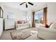 Bright bedroom featuring a daybed, large windows with great light, and neutral decor at 5582 Twilight Way, Parker, CO 80134
