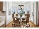 Cozy breakfast nook with a round table, four chairs, plantation shutters, and a chandelier at 5582 Twilight Way, Parker, CO 80134