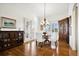 Bright dining area featuring hardwood floors, shuttered windows, and a classic chandelier at 5582 Twilight Way, Parker, CO 80134