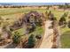 Gorgeous two-story home featuring a tile roof, well-manicured lawn, and a long driveway at 5582 Twilight Way, Parker, CO 80134