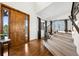 Bright foyer features a hardwood floor, staircase with iron railing and large entry door at 5582 Twilight Way, Parker, CO 80134