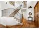 Grand two-story foyer featuring hardwood floors, iron staircase, and natural light at 5582 Twilight Way, Parker, CO 80134